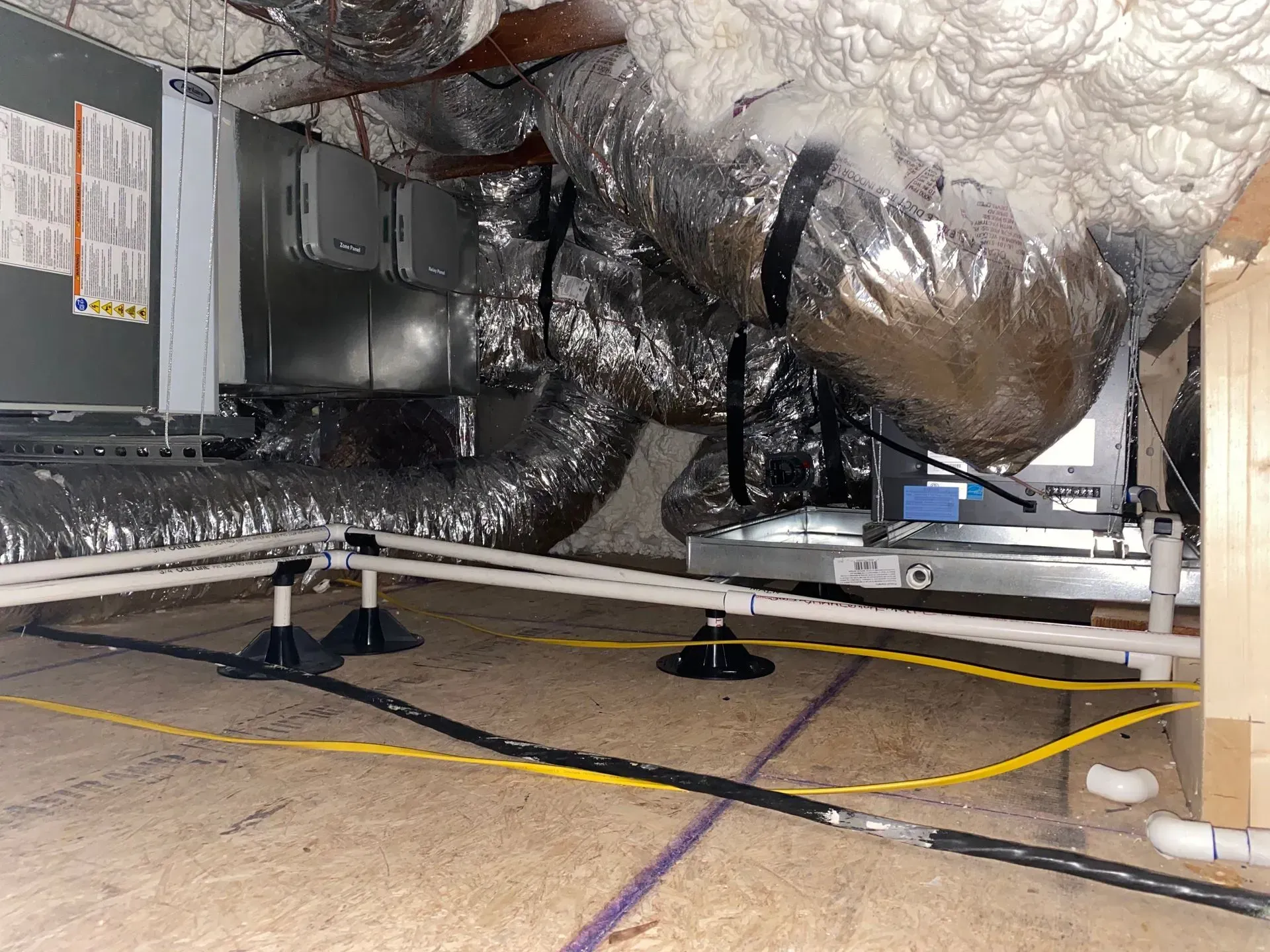 A room with a lot of pipes and wires in it