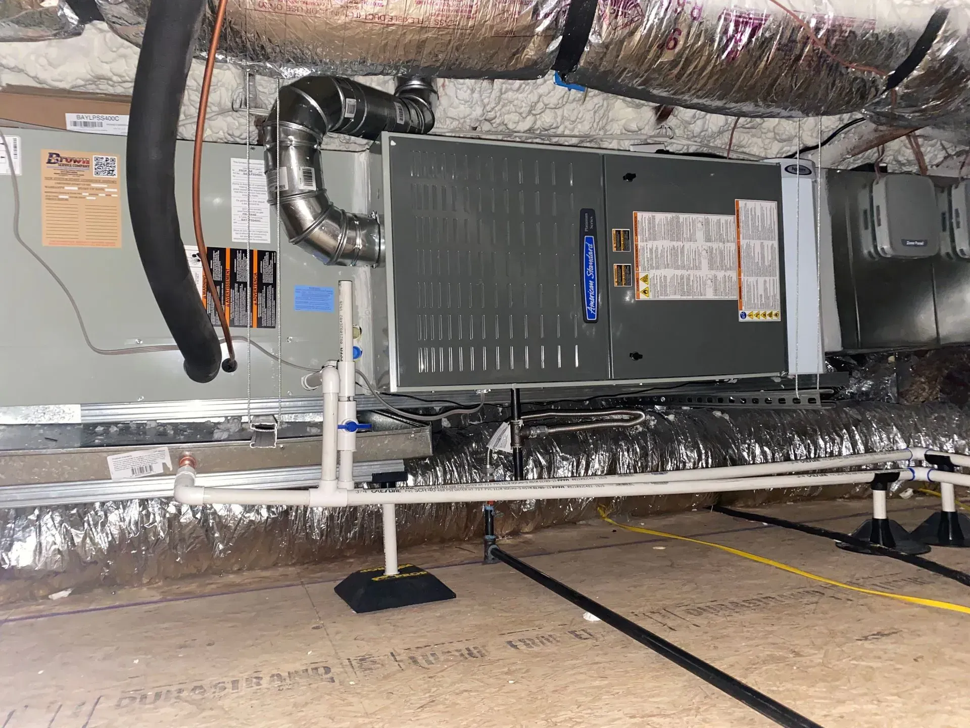 A picture of an air conditioner in a basement.