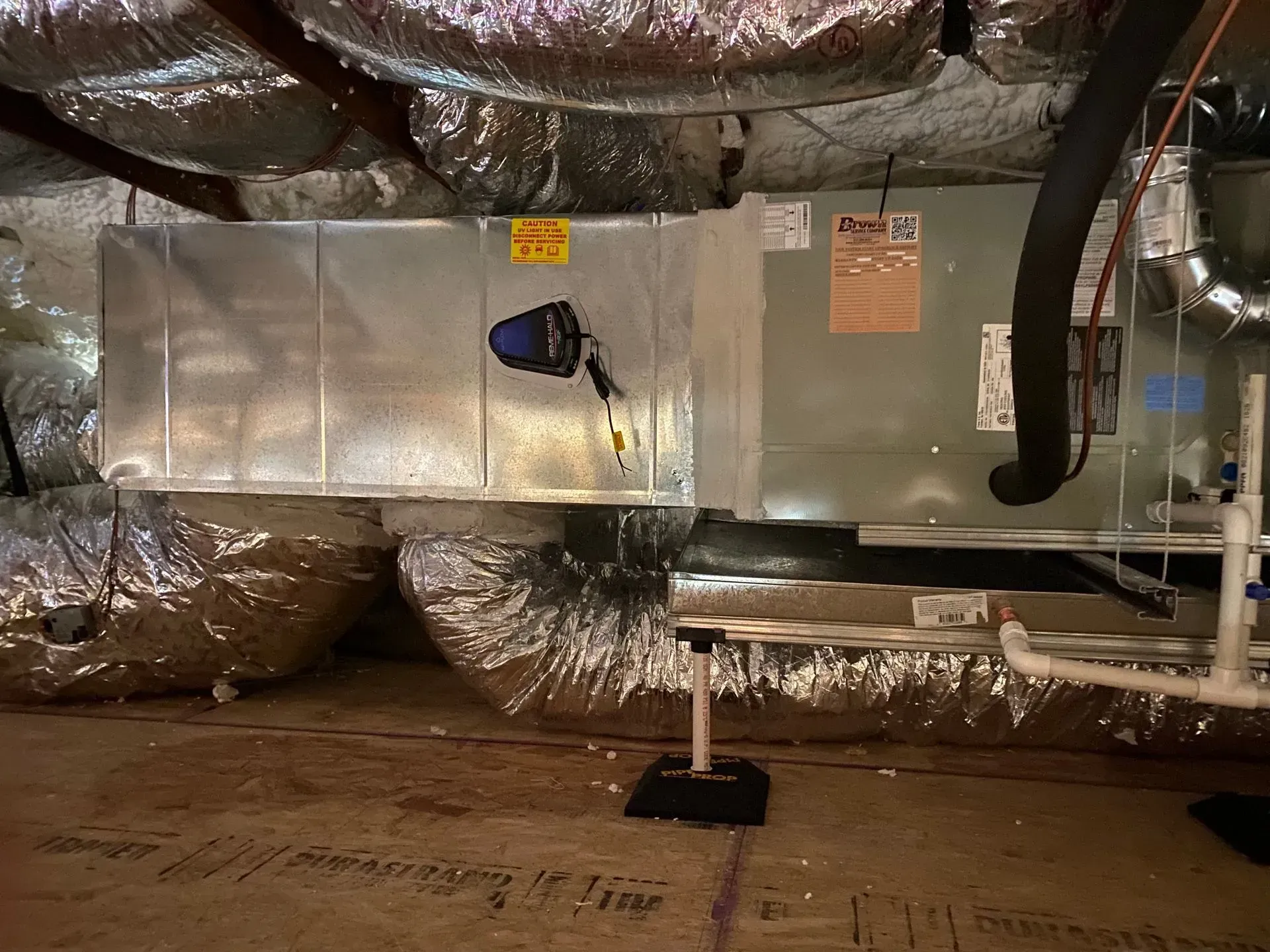 A room with a lot of pipes and ducts in it.