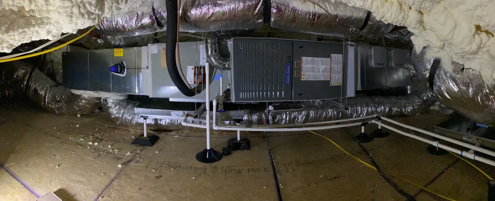 A picture of an air conditioner in a basement.