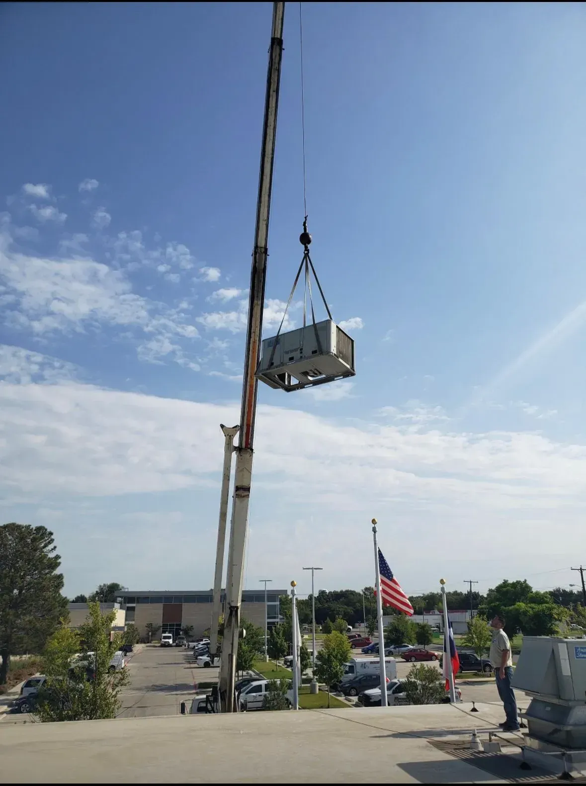 A crane is lifting a piece of equipment in the air