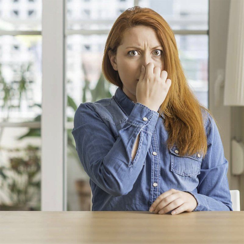 Woman Holding Her Nose