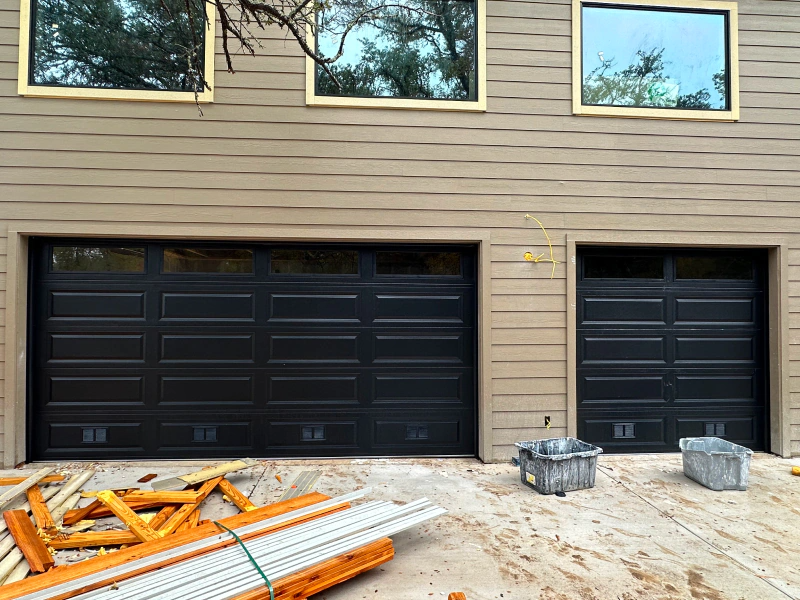 A garage door is being installed on the side of a house.
