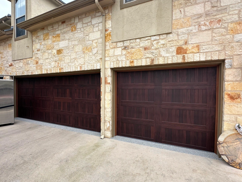 A row of garage doors on a brick building