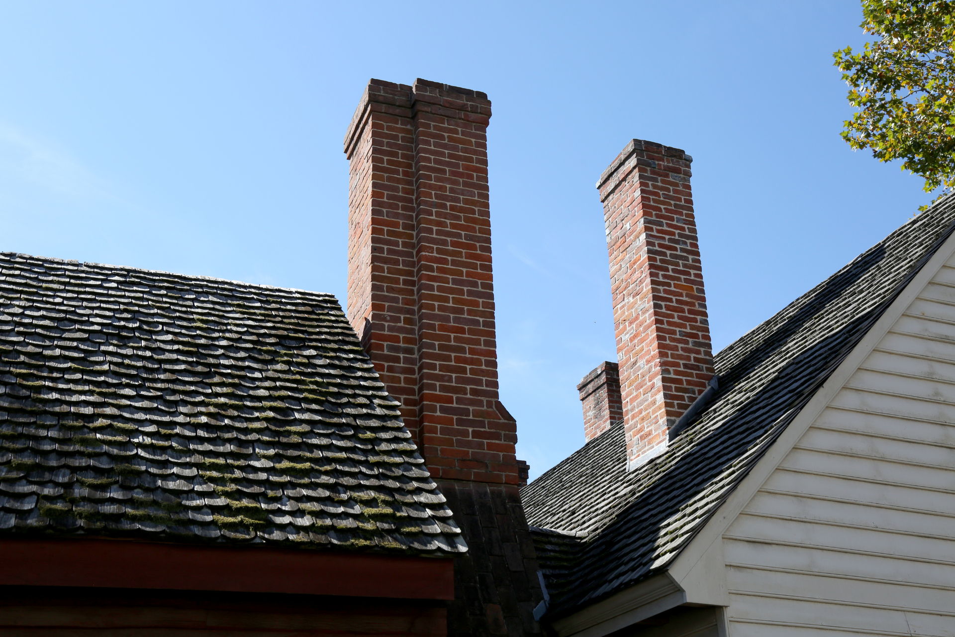 A brick chimney on the roof of a house