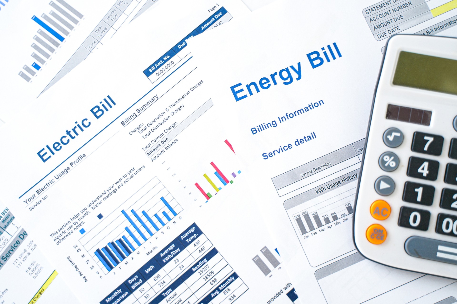 A calculator is sitting on top of an electric bill.