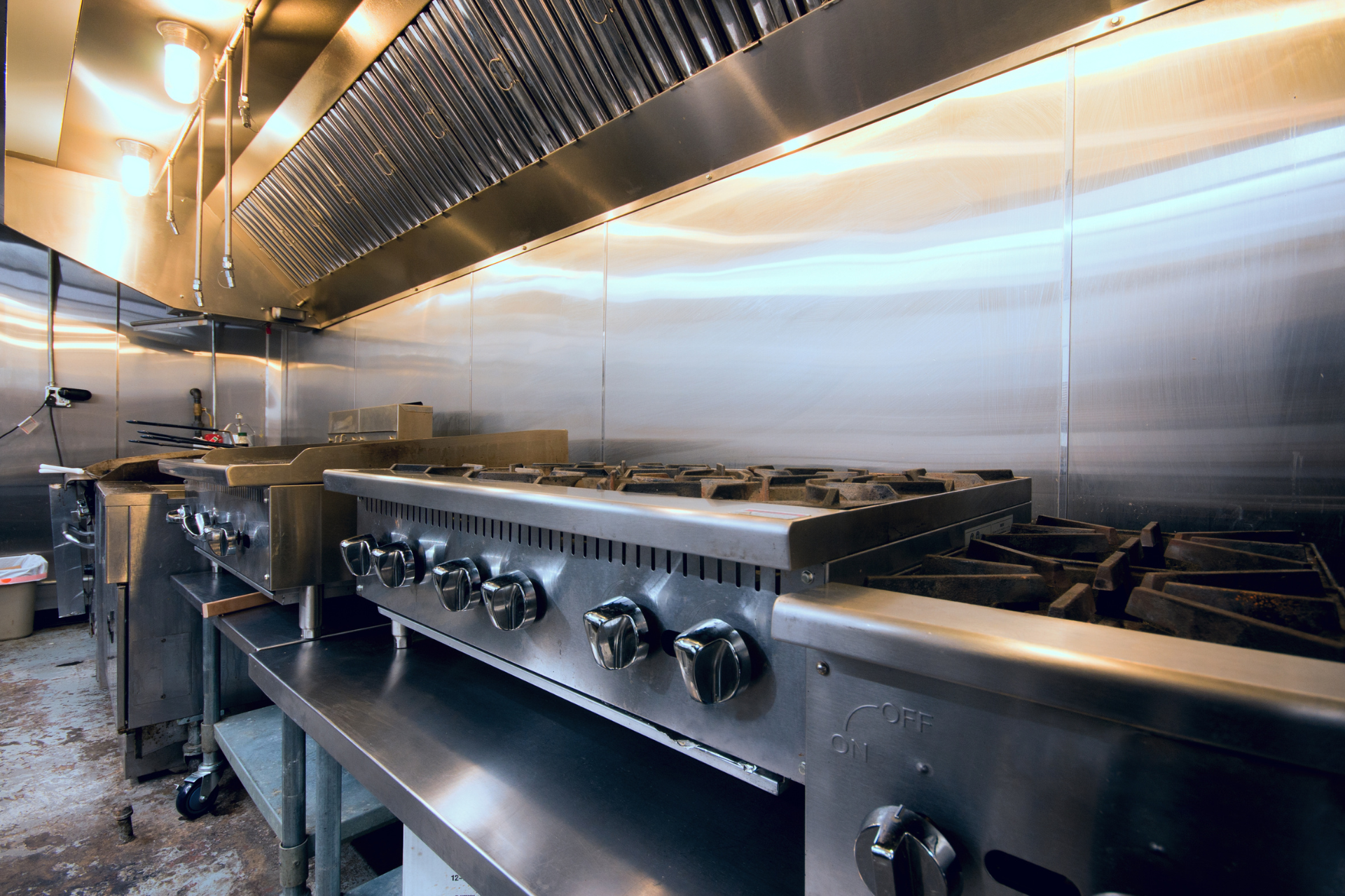 A kitchen with stainless steel appliances and a stove