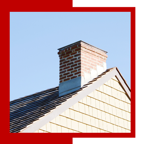 a brick chimney is on the roof of a house .