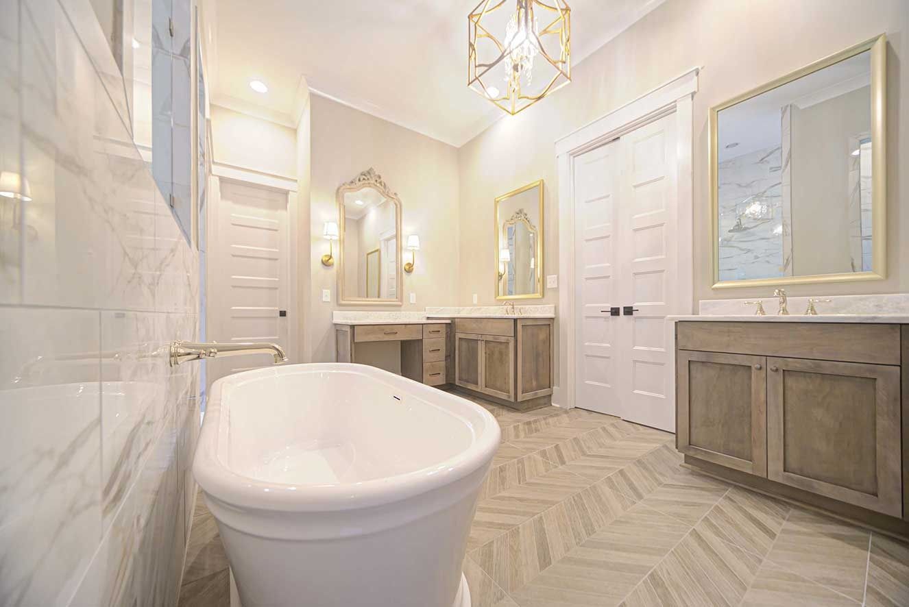 Luxurious white bathroom with freestanding tub, marble walls, and vanity mirrors