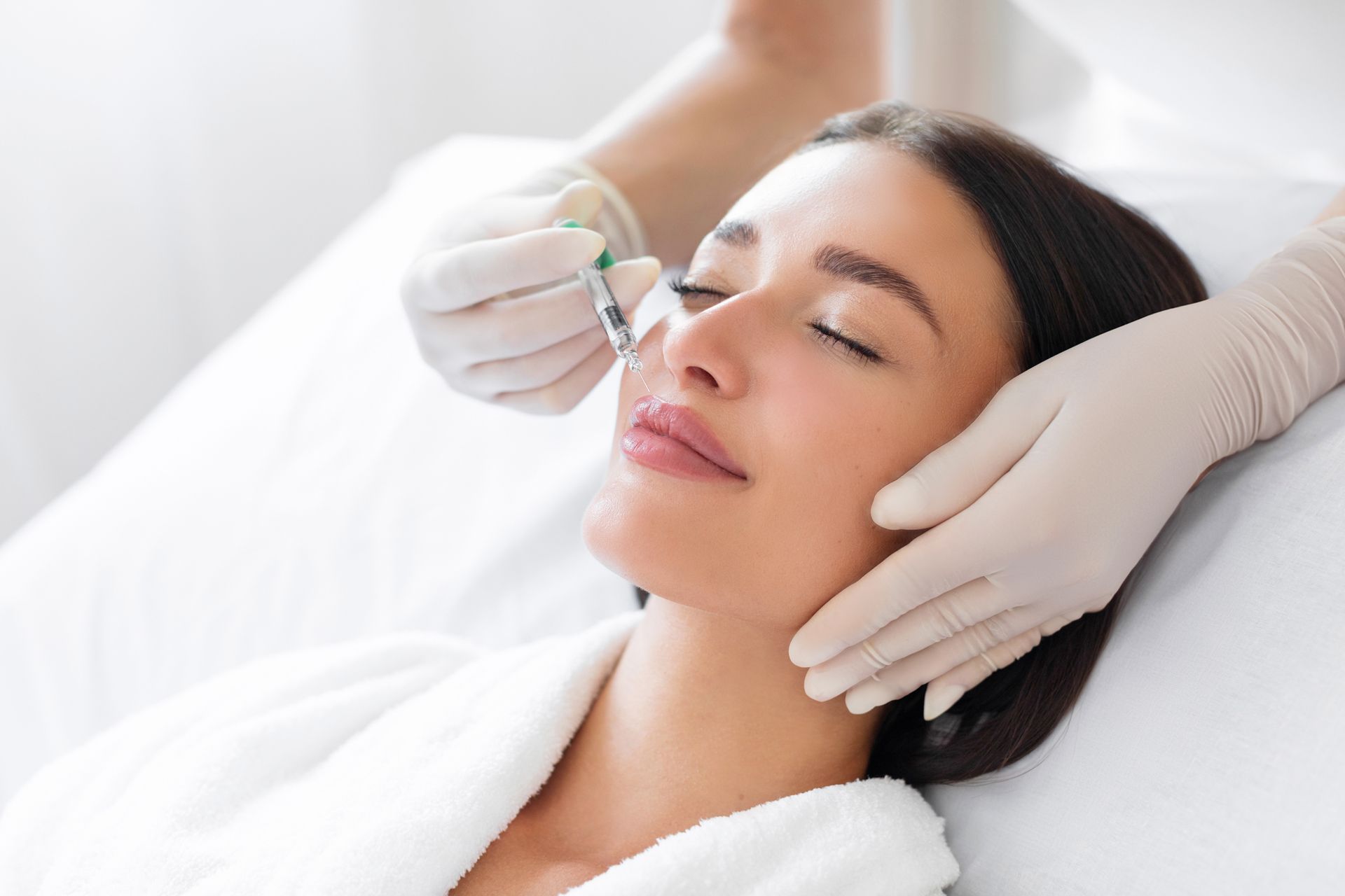 Person receiving a facial injection on their face. 