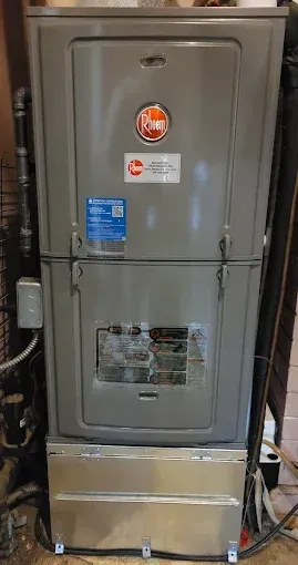 Gray Rheem HVAC unit in a residential setting.