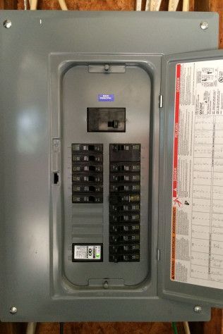 A close up of a electrical panel with the door open.