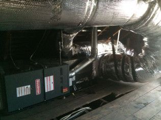 A room with a lot of pipes and boxes in it.