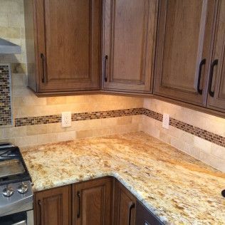 A kitchen with wooden cabinets and granite counter tops.