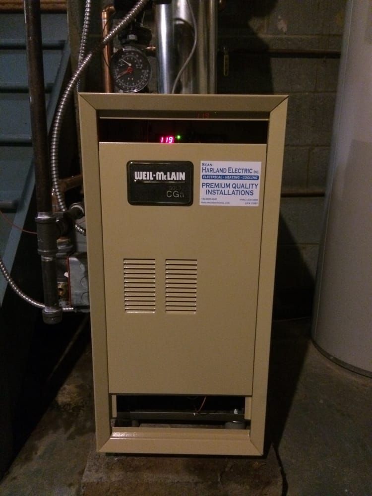 An air-main heater is sitting next to a water heater