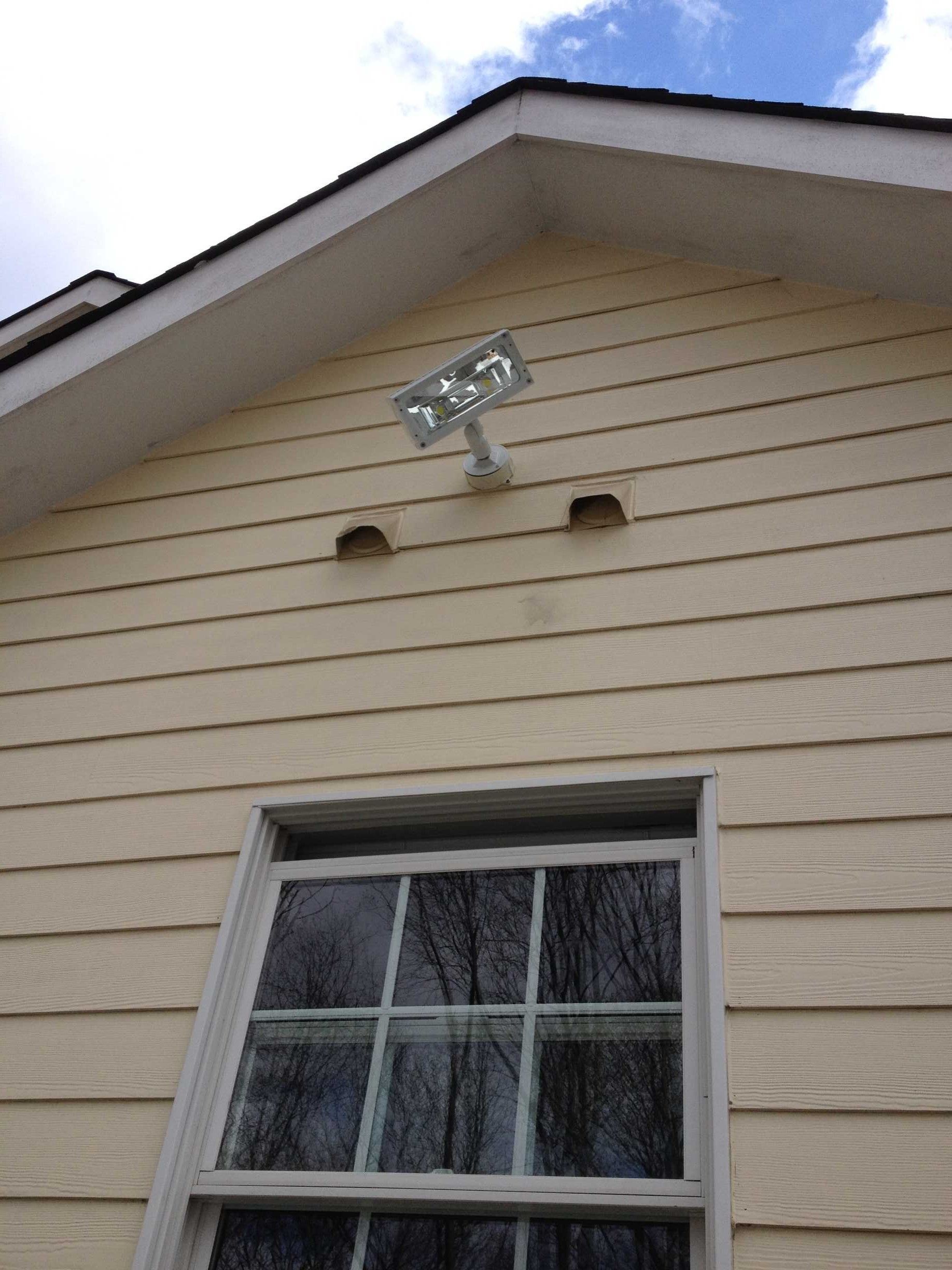 A house with a window and a light on top of it.