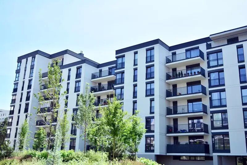A large apartment building with a lot of windows and balconies.