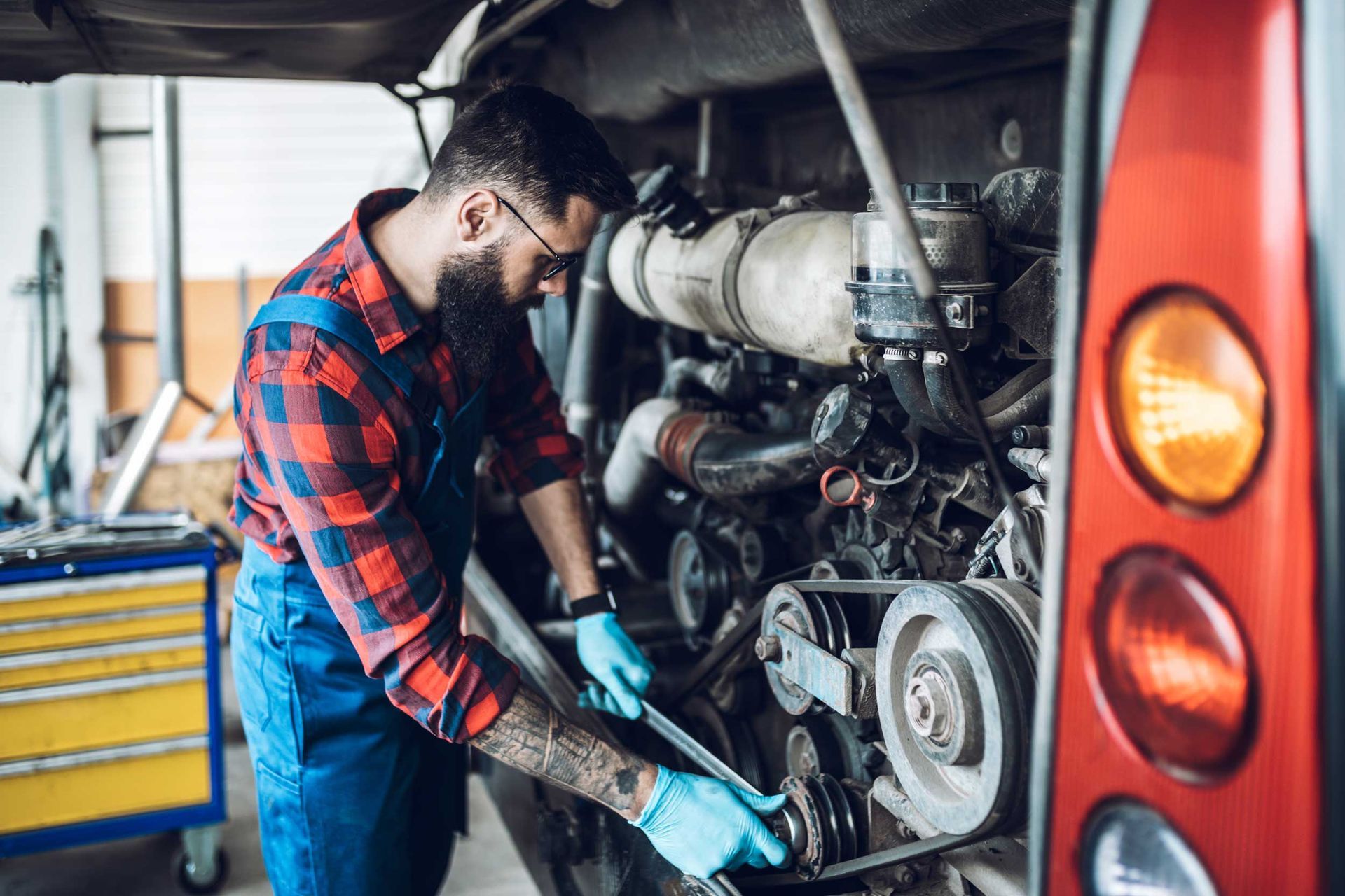 Professional bus mechanic working in vehicle repair service.