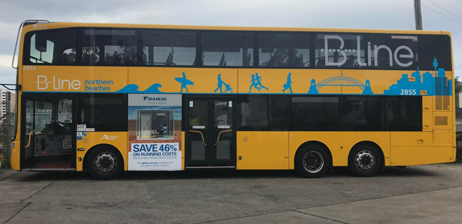 Serviceman with digital tablet. In the background is a bus in the garage. Serviceman with digital tablet. In the background is a bus in the garage.