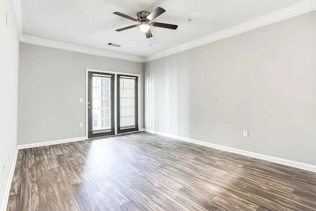 Bedroom with wooden floor and ceiling fan and light at Preserve at Mill Creek, Buford, Georgia