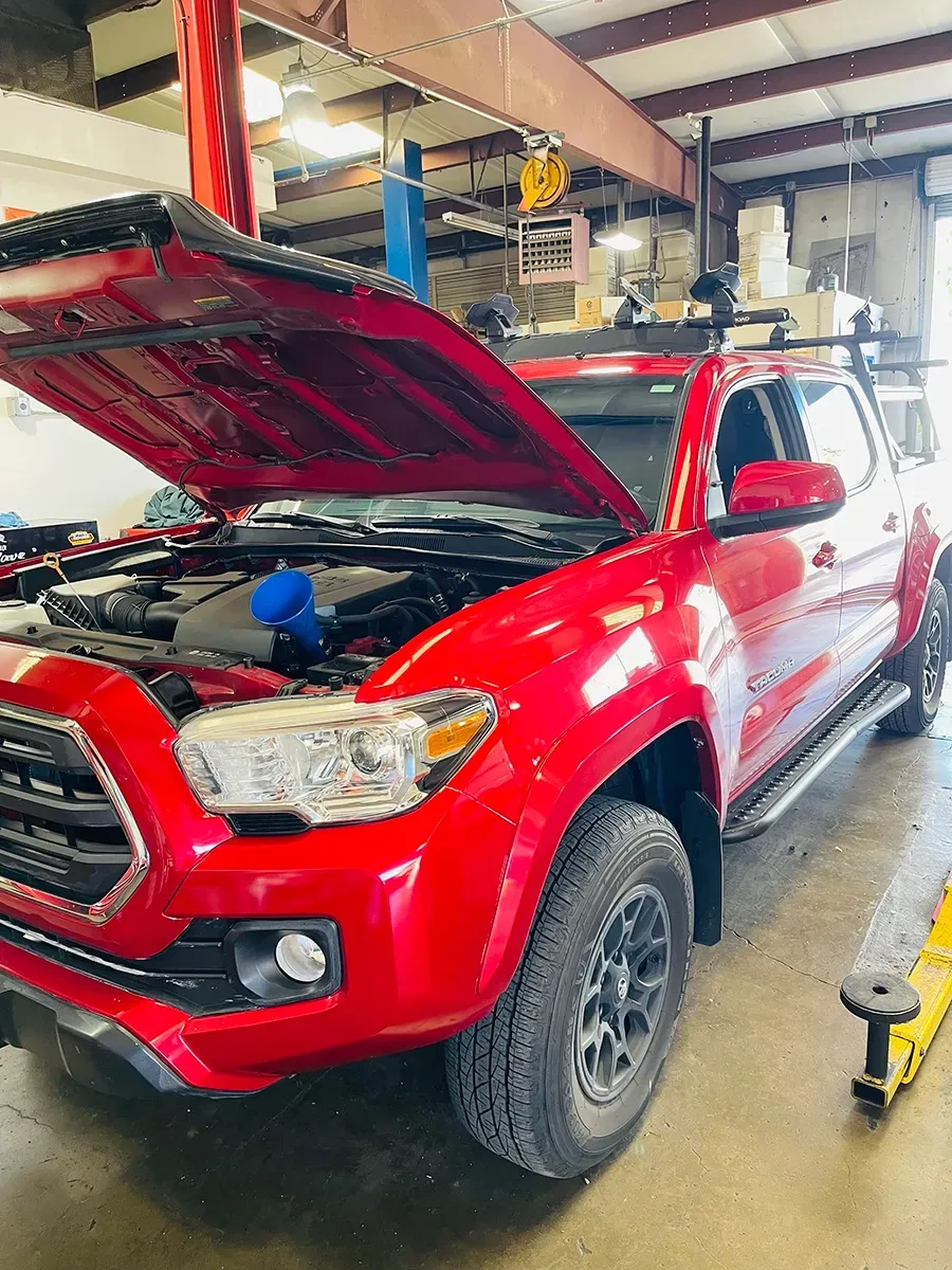Transmission Fluid, red vehicle with hood up | Asian Imports Garage