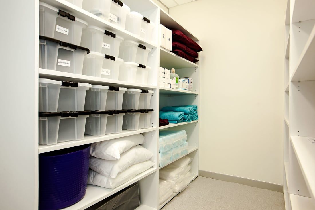 A closet filled with lots of shelves and bins.