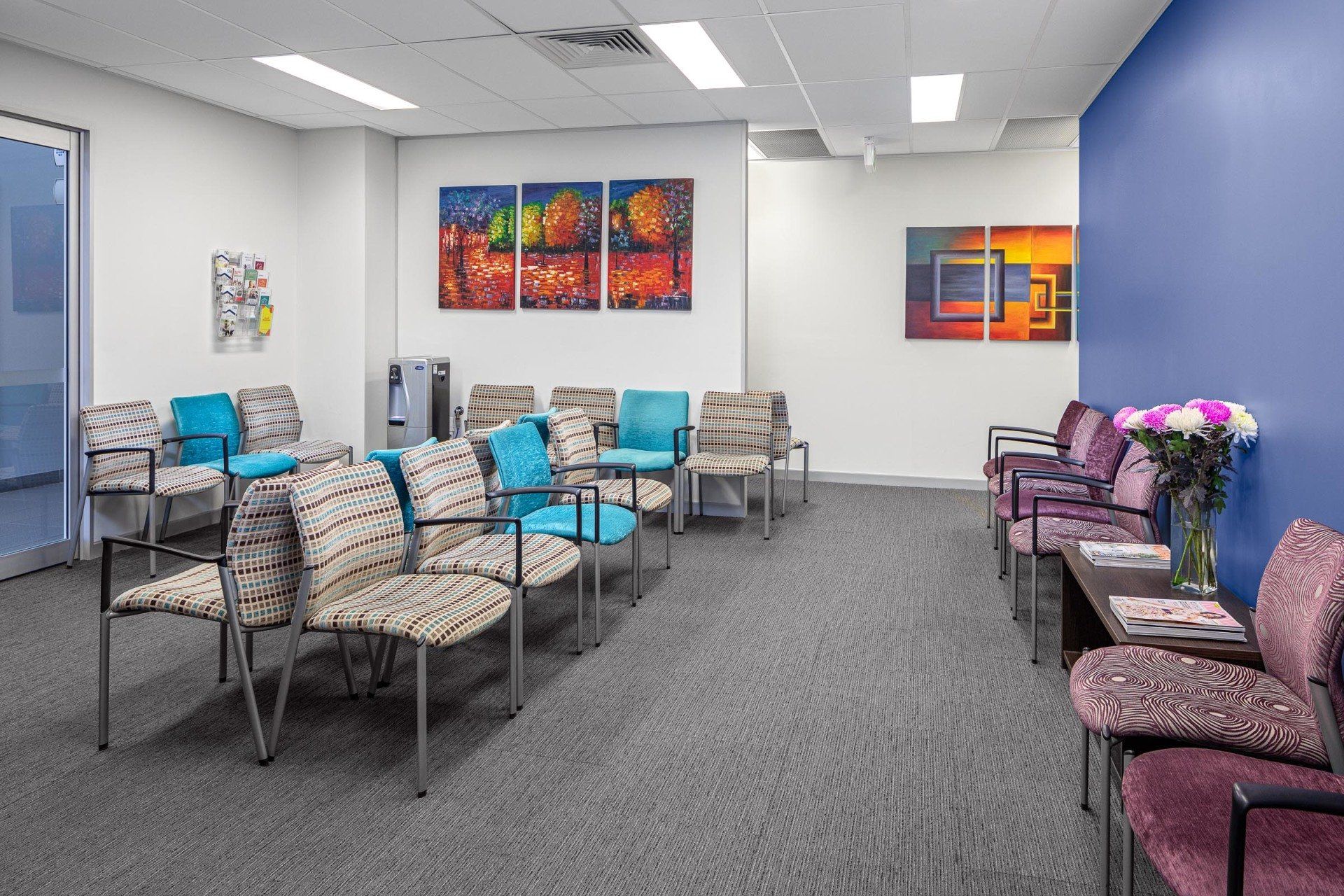 A waiting room with a lot of chairs and tables