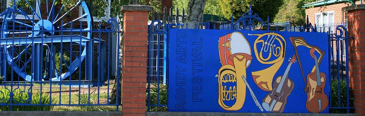 a blue fence with a painting of instruments on it