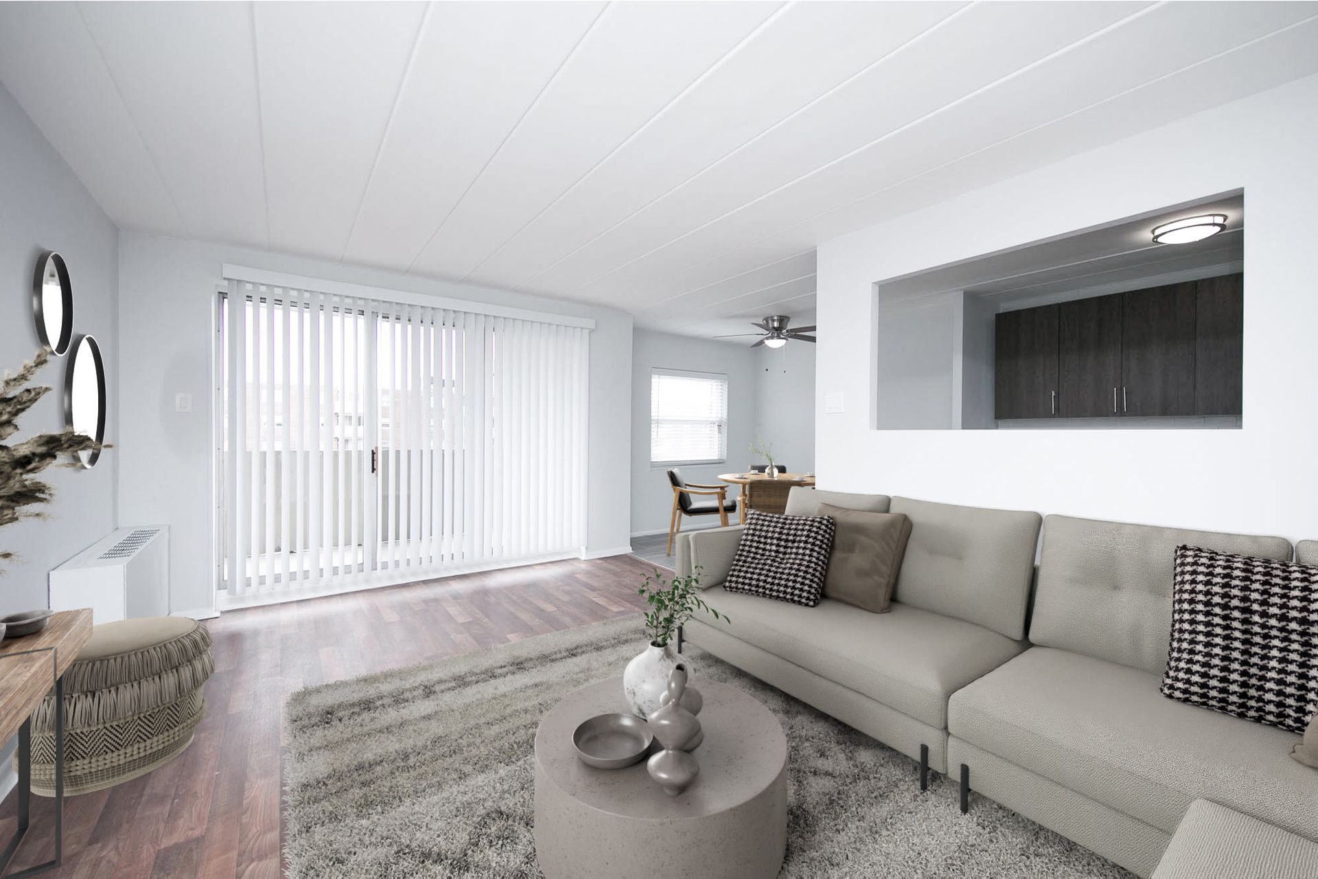 Bright living room with beige sectional sofa, coffee table, and open kitchen pass-through.