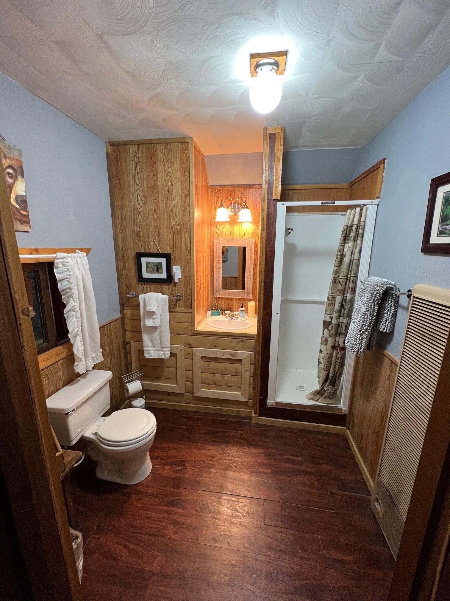 A bathroom with a toilet , sink , and shower.