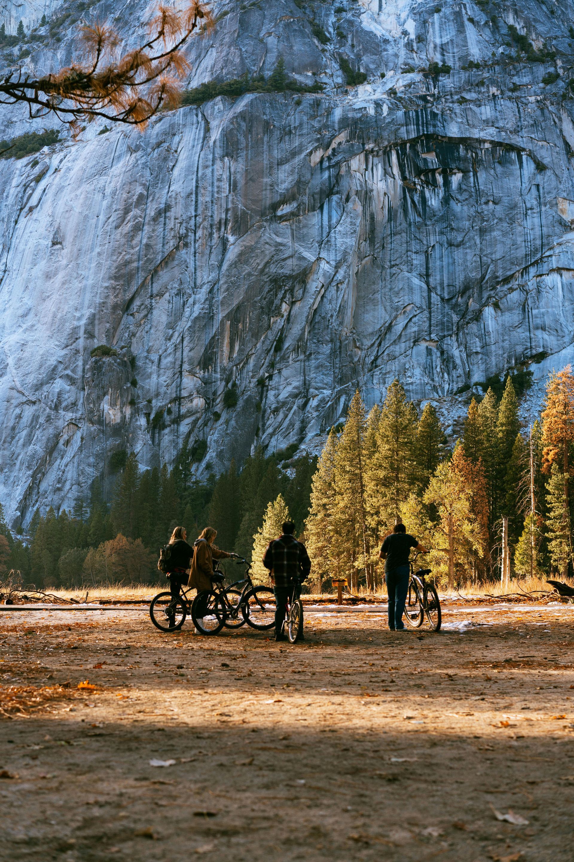A group of people are standing in front of a mountain.