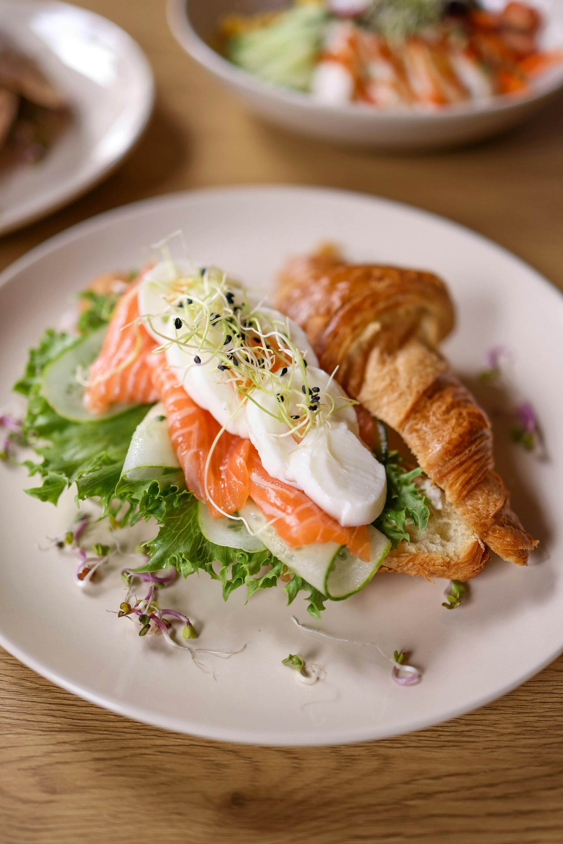 A close up of a sandwich on a plate on a table.