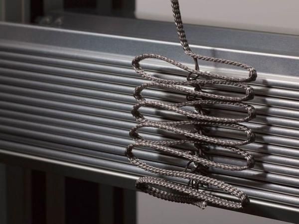 Eine Nahaufnahme eines Seils, das von einem Metallgeländer hängt.