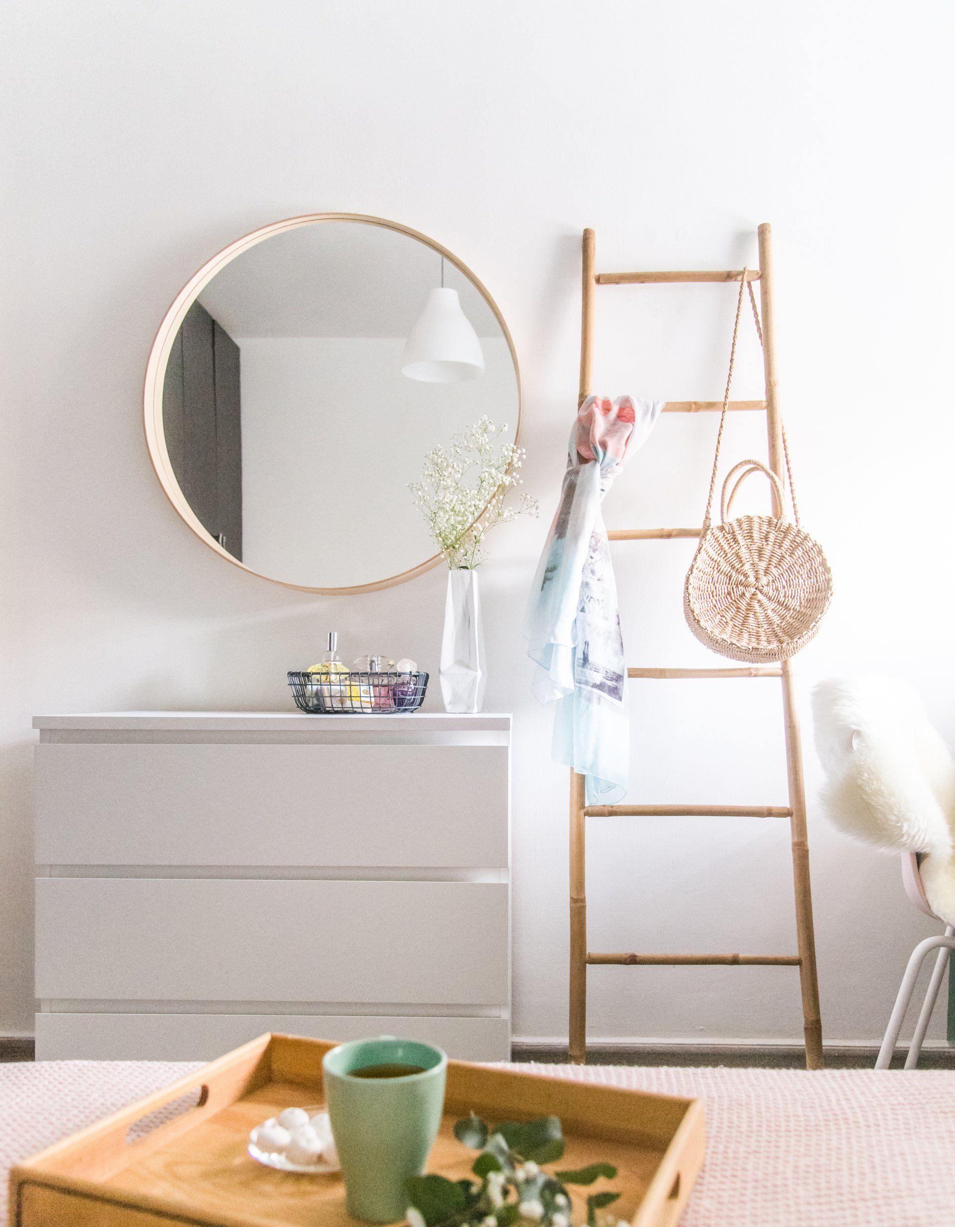 שידה לבנה מראה עגולה וסולם במבוק לתליית בגדים