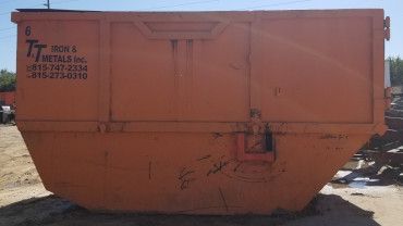 A large orange industrial metal dumpster, labeled with 