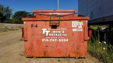 An orange dumpster labeled 