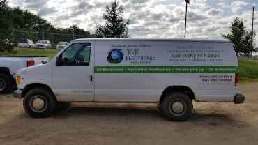 A white work van parked outdoors with 