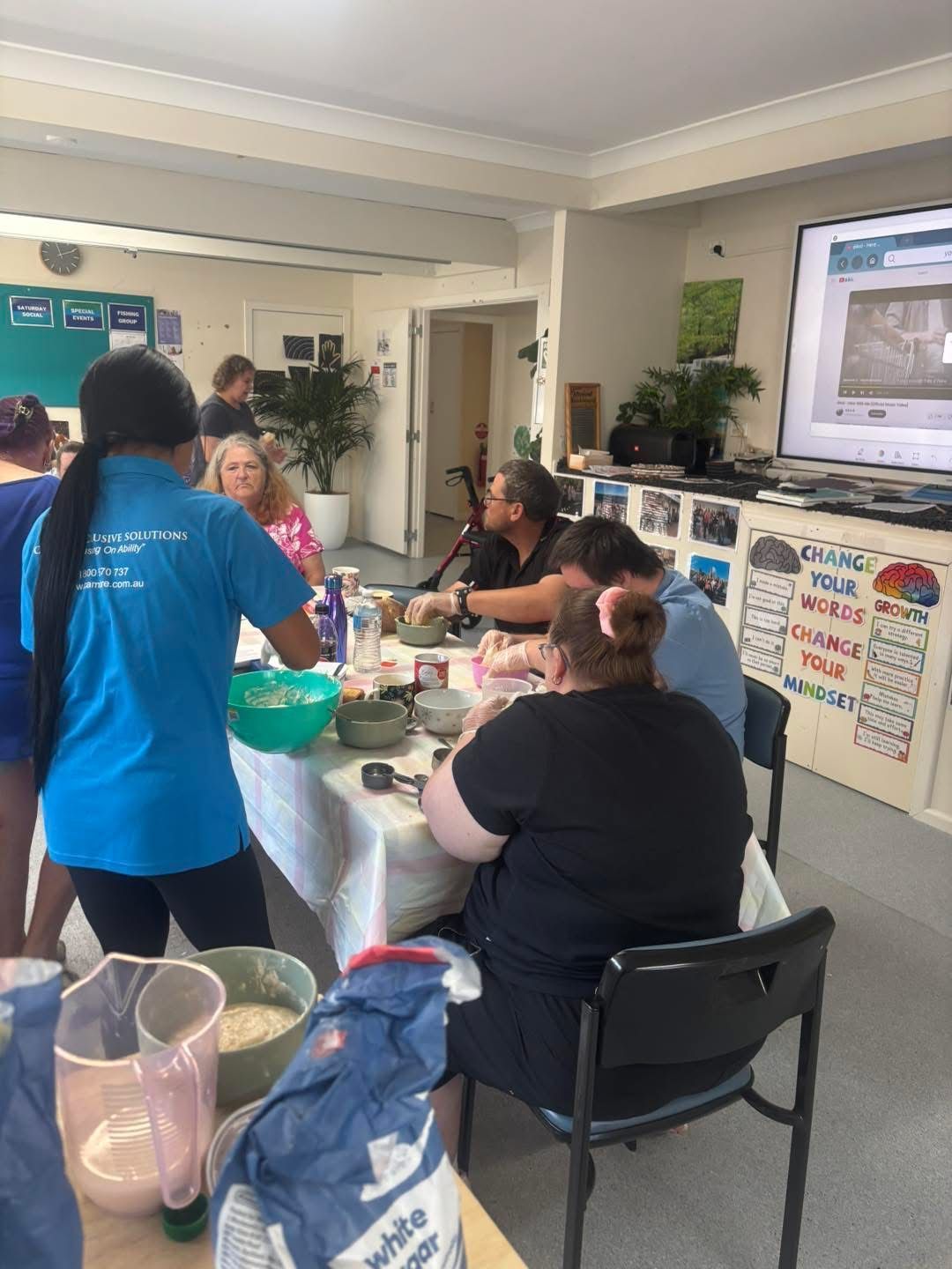 A group of people are sitting around a table in a room.