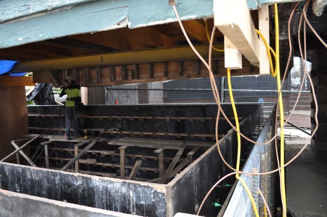 a construction site with a lot of wires hanging from the ceiling