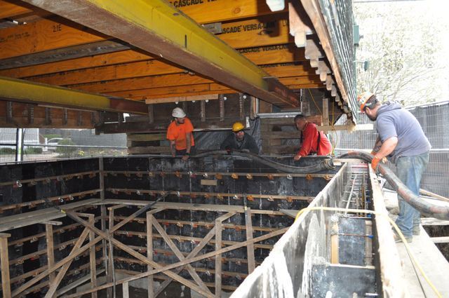 a group of construction workers are working on a building under construction