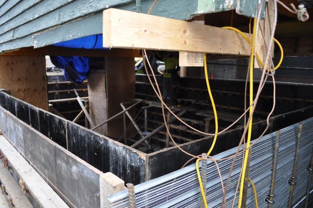 a building under construction with a bunch of wires coming out of it