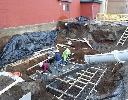 a group of men are working on a construction site