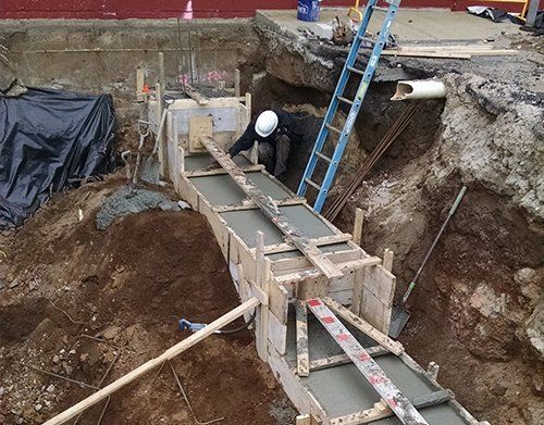 a man wearing a hard hat is working on a construction site