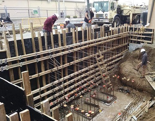a group of construction workers are working on a building under construction