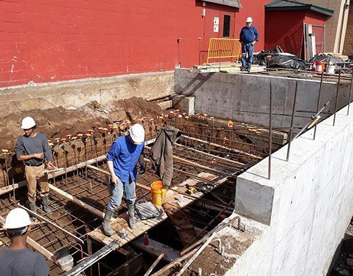 a group of construction workers are working on a construction site