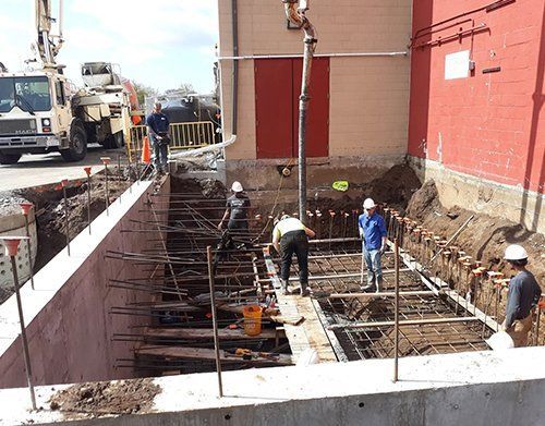a group of construction workers are working on a buildin