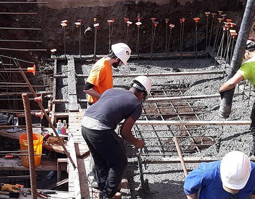 a group of construction workers are working on a construction site