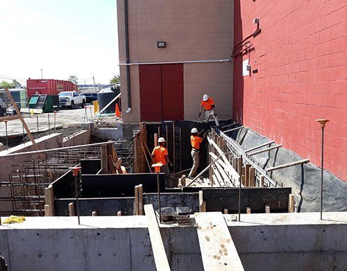 a group of construction workers are working on a building