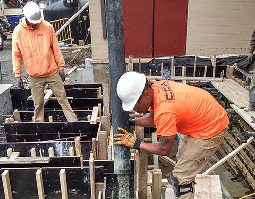 two construction workers are working on a construction site