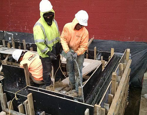 a group of construction workers are working on a construction site
